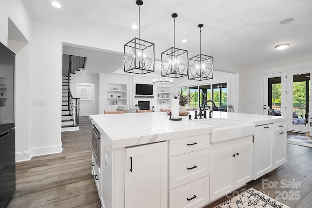 1005 Grand Oak Dr, Waxhaw, NC 28173 - kitchen featuring a sink, recessed lighting, an island with sink, white cabinetry, and wood finished floors