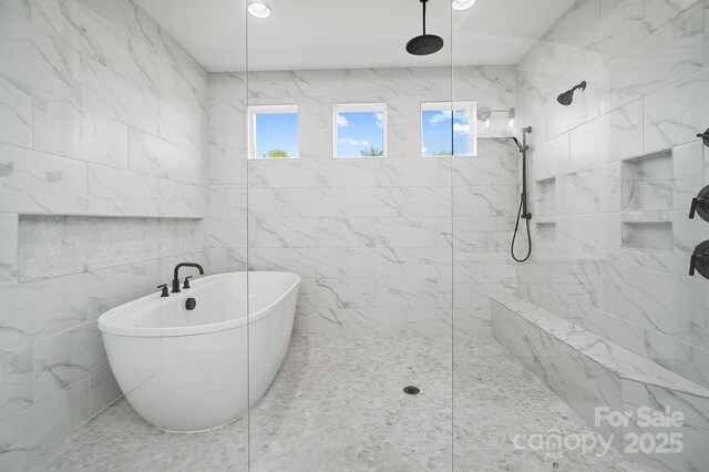 1005 Grand Oak Dr, Waxhaw, NC 28173 - bathroom featuring a marble finish shower, a freestanding bath, and tile walls