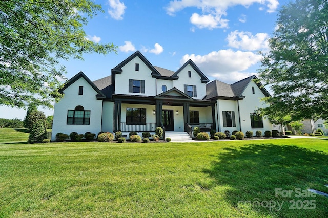 1005 Grand Oak Dr, Waxhaw, NC 28173 - view of front facade featuring a porch, a front lawn, and stucco siding