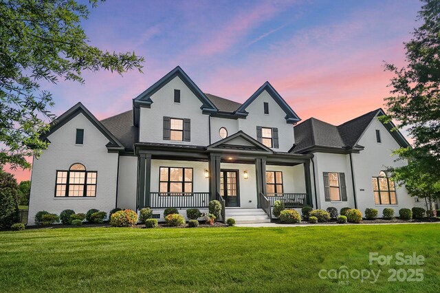 1005 Grand Oak Dr, Waxhaw, NC 28173 - view of front of property featuring a porch, a lawn, and roof with shingles