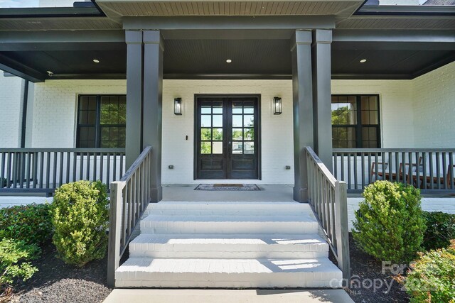 1005 Grand Oak Dr, Waxhaw, NC 28173 - doorway to property with a porch, brick siding, and french doors
