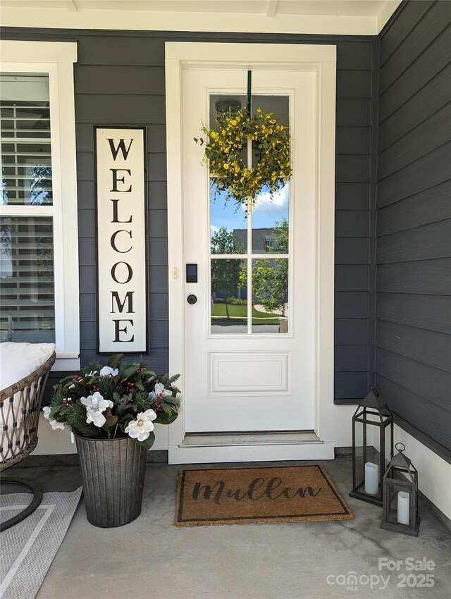 view of exterior entry featuring a porch