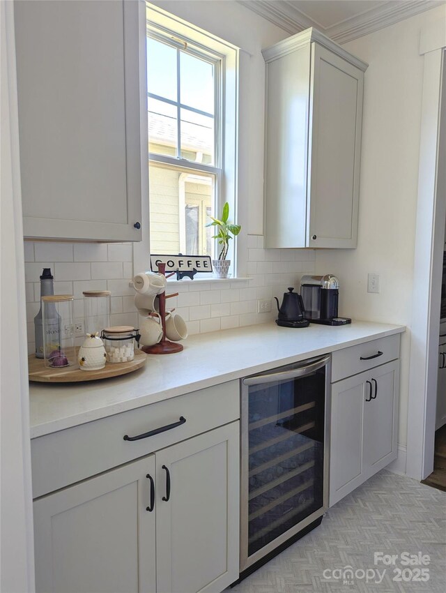 bar with decorative backsplash, ornamental molding, and beverage cooler