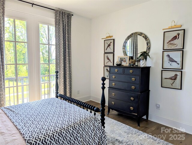 bedroom featuring baseboards and wood finished floors