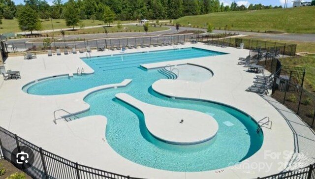 pool featuring a patio and fence