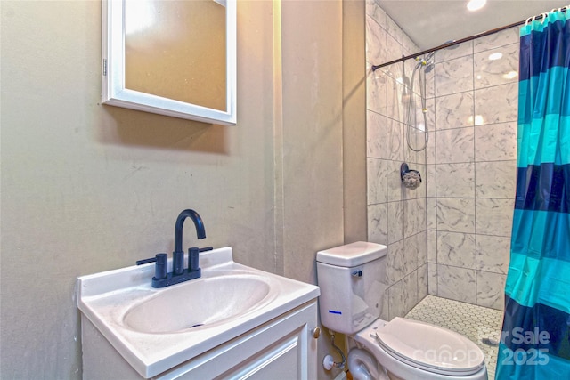 bathroom with vanity, a stall shower, and toilet