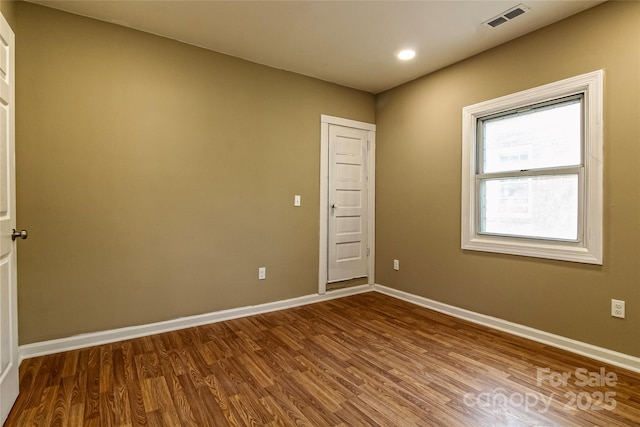 unfurnished room with recessed lighting, baseboards, visible vents, and wood finished floors