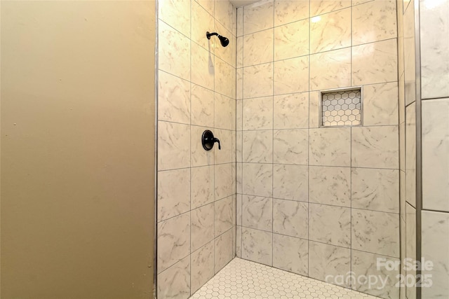 full bath featuring a tile shower