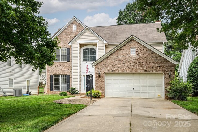 16017 Woodcote Dr, Huntersville, NC 28078 - traditional-style house with brick siding, central AC, driveway, a front yard, and a garage