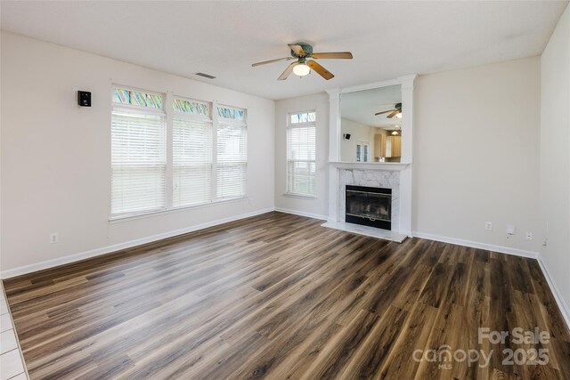 16017 Woodcote Dr, Huntersville, NC 28078 - unfurnished living room featuring a ceiling fan, wood finished floors, a fireplace, and baseboards