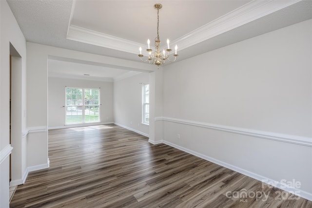 16017 Woodcote Dr, Huntersville, NC 28078 - empty room featuring a chandelier, wood finished floors, a raised ceiling, ornamental molding, and baseboards