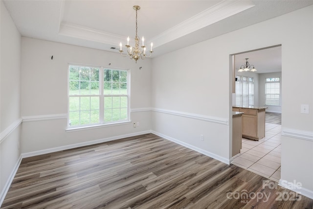 16017 Woodcote Dr, Huntersville, NC 28078 - empty room featuring a chandelier, crown molding, light wood finished floors, a raised ceiling, and baseboards