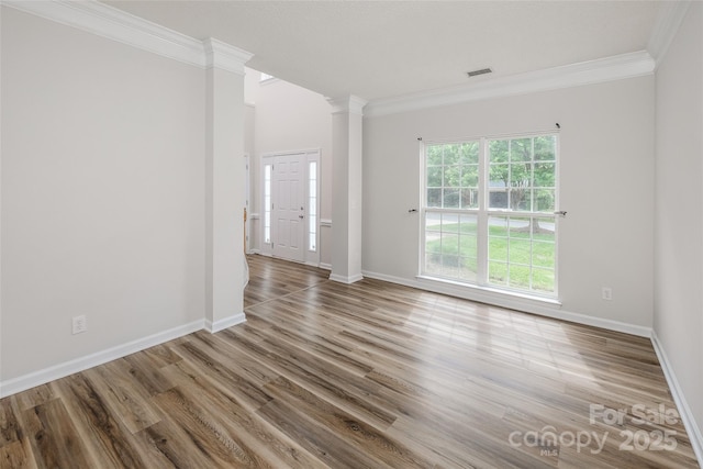 16017 Woodcote Dr, Huntersville, NC 28078 - empty room with ornate columns, crown molding, wood finished floors, and baseboards