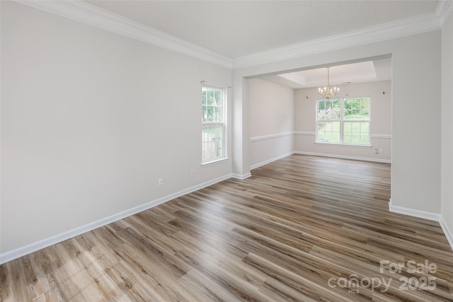 16017 Woodcote Dr, Huntersville, NC 28078 - spare room with a chandelier, crown molding, wood finished floors, baseboards, and a raised ceiling