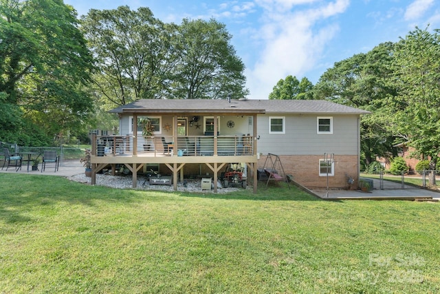back of house with a yard, fence, a wooden deck, and a gate