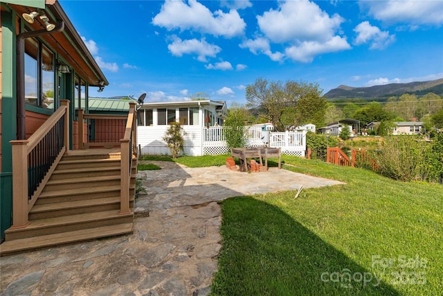 214 Pike Pt, Waynesville, NC 28785 - view of yard featuring a deck with mountain view, a patio, a sunroom, and stairway