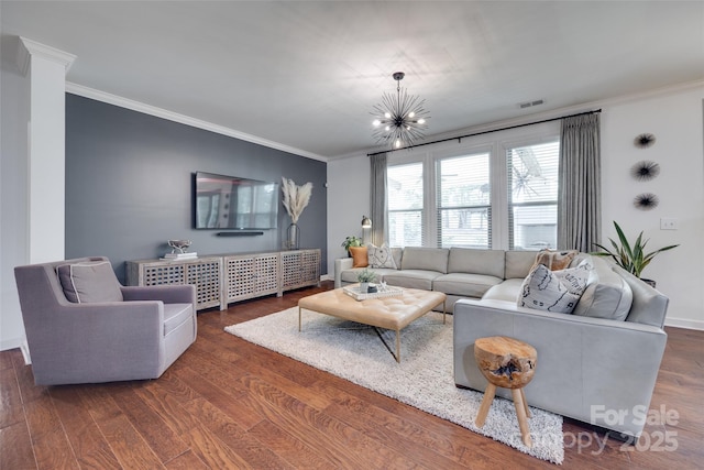 living area featuring crown molding, visible vents, and wood finished floors