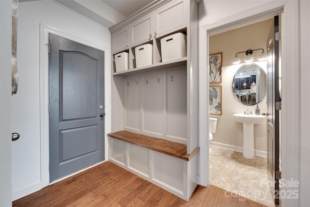 mudroom with light wood finished floors