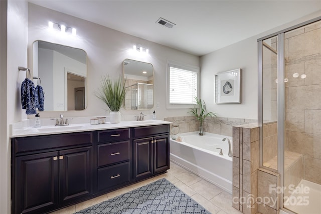 full bath with visible vents, a garden tub, tile patterned floors, a sink, and a stall shower