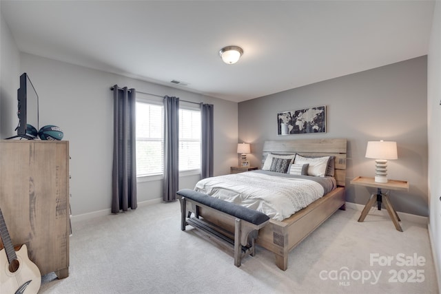 bedroom featuring visible vents, baseboards, and light carpet