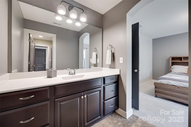 bathroom with baseboards, visible vents, and vanity