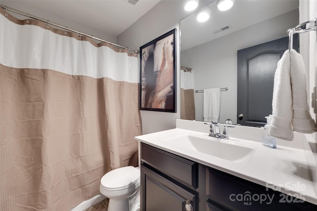 bathroom with toilet, visible vents, a shower with shower curtain, and vanity