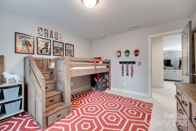 bedroom featuring baseboards and light carpet