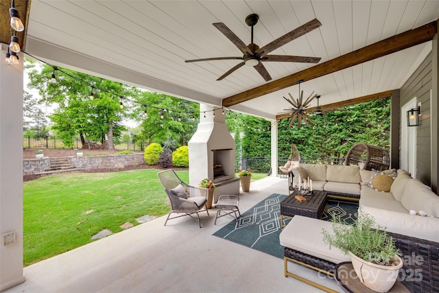 view of patio / terrace featuring fence, a ceiling fan, and an outdoor living space with a fireplace