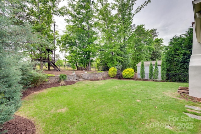 view of yard featuring stairway and fence