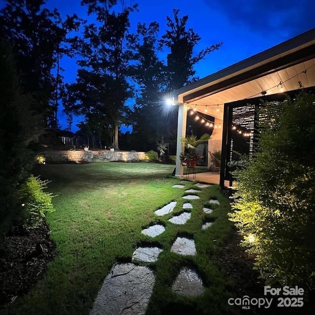 view of yard at twilight