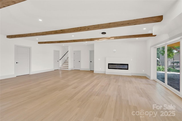 124 Clipper Ln, Mooresville, NC 28117 - unfurnished living room with light wood-style floors, recessed lighting, beam ceiling, stairs, and a glass covered fireplace