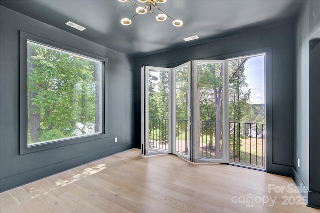 124 Clipper Ln, Mooresville, NC 28117 - unfurnished room with a chandelier and wood finished floors