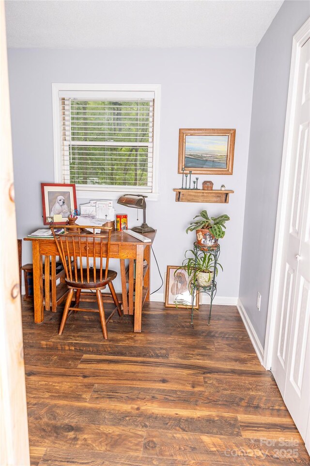 office space featuring baseboards and wood finished floors
