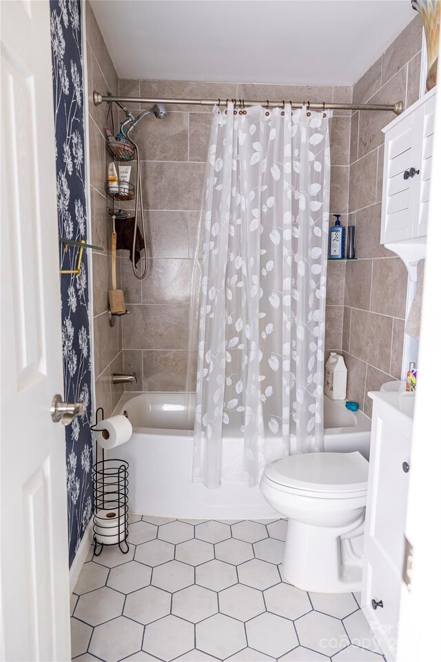 bathroom featuring vanity, shower / bath combo with shower curtain, and toilet