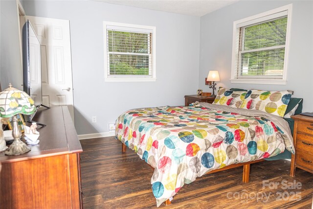 bedroom with baseboards and wood finished floors