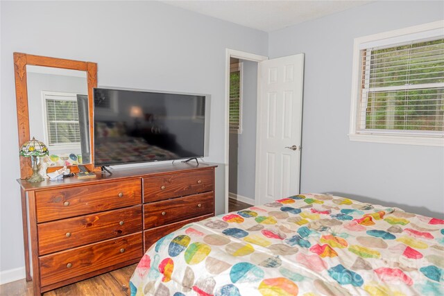 bedroom featuring baseboards and wood finished floors