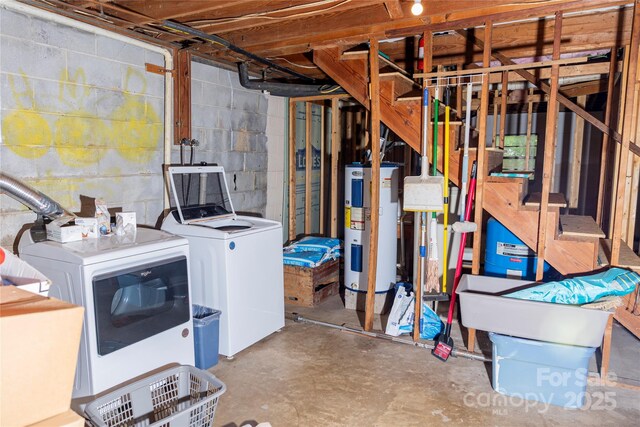 unfinished basement featuring water heater, washer and dryer, and concrete block wall