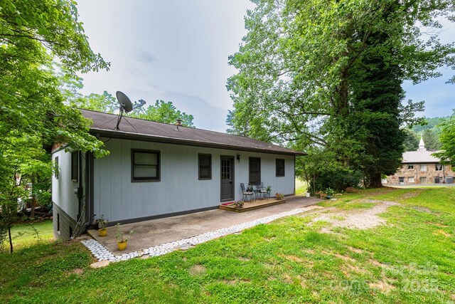 57 Gribble Rd, Franklin, NC 28734 - back of house featuring a patio area and a lawn