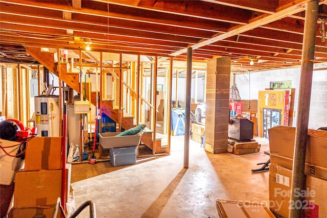 57 Gribble Rd, Franklin, NC 28734 - below grade area featuring stairway, water heater, and concrete block wall
