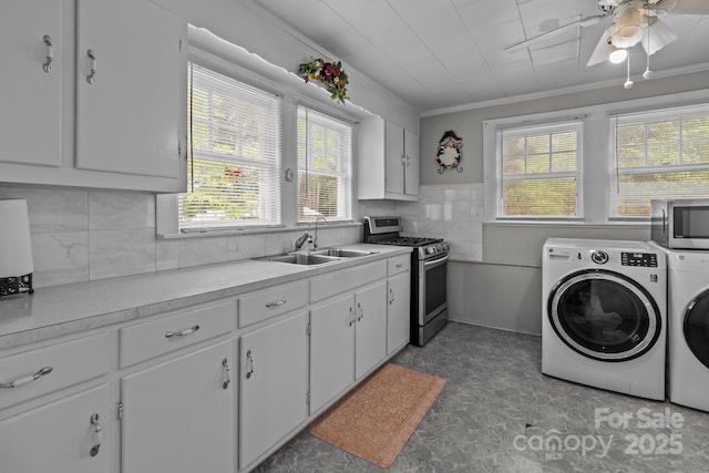 laundry room with separate washer and dryer, a sink, crown molding, and a wealth of natural light