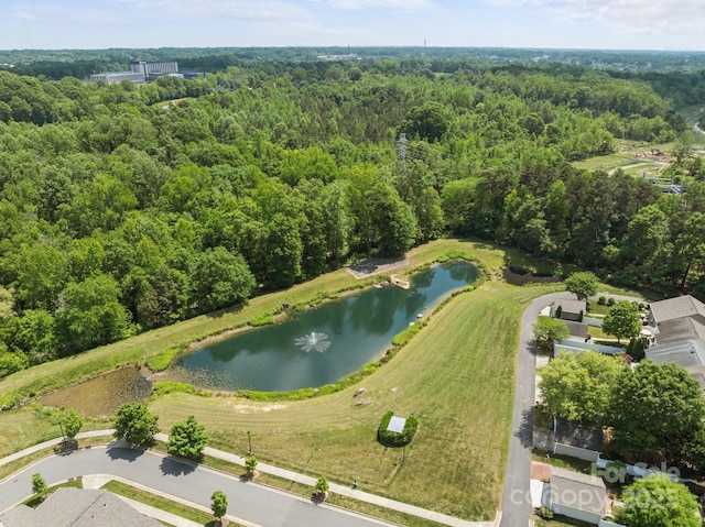birds eye view of property with a water view and a wooded view