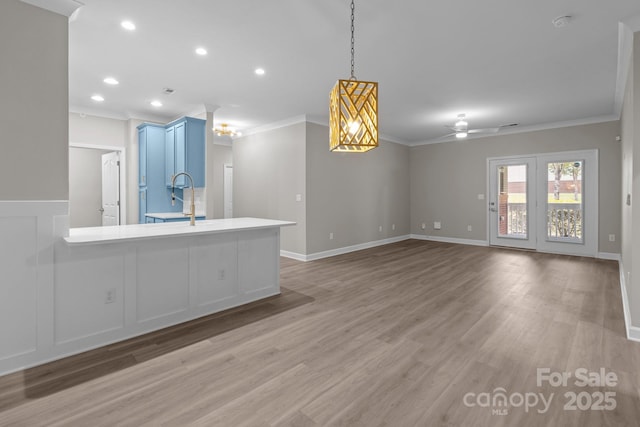 unfurnished living room featuring recessed lighting, ornamental molding, a ceiling fan, and light wood-type flooring