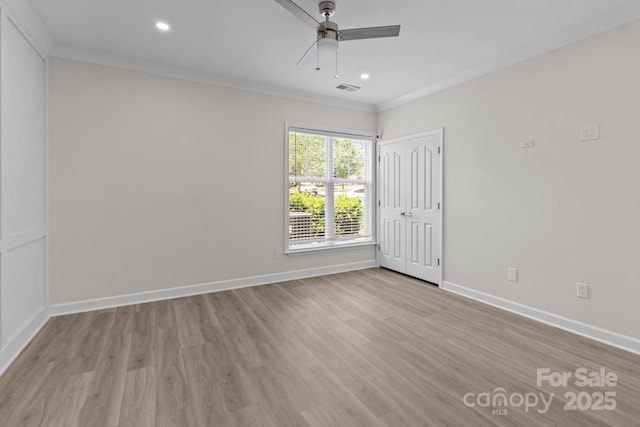 unfurnished bedroom featuring crown molding, baseboards, light wood finished floors, and visible vents