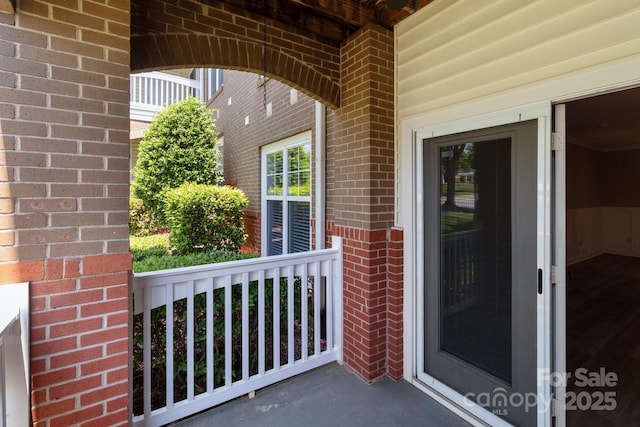 doorway to property featuring brick siding
