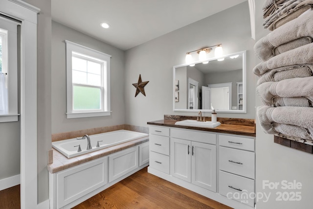 2853 Mathis Church Rd, Catawba, NC 28609 - bathroom with vanity, a garden tub, wood finished floors, and recessed lighting