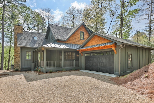 view of front of property with roof with shingles, a garage, board and batten siding, a standing seam roof, and covered porch