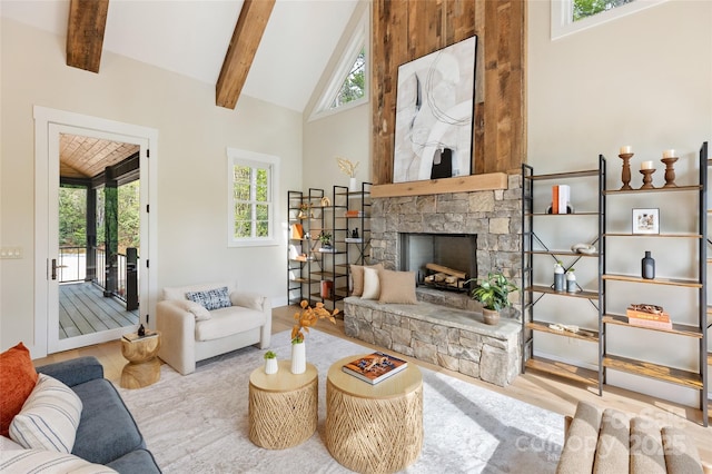 living area with beamed ceiling, a wealth of natural light, high vaulted ceiling, and wood finished floors
