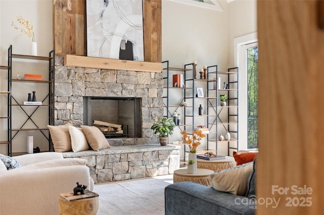living area featuring a stone fireplace