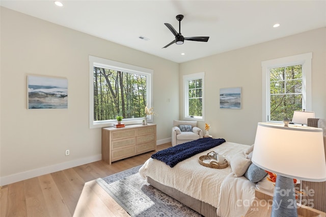 bedroom with a ceiling fan, visible vents, baseboards, recessed lighting, and light wood-style flooring