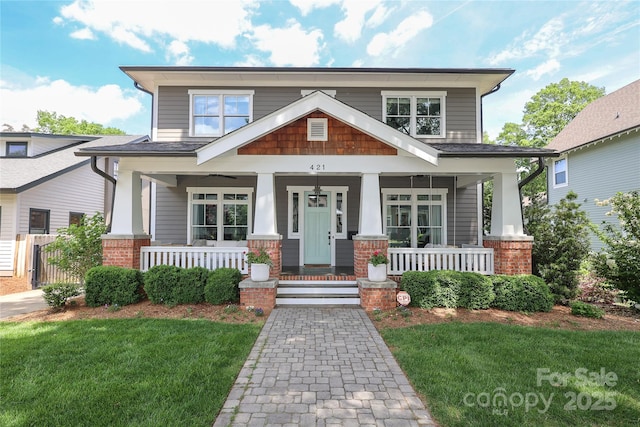 craftsman house with a front yard and a porch